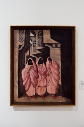 A painting of Arabic ladies wearing pink robes
