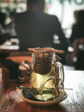 A glass of tea with a strainer