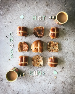 hot cross buns in a square with two cups of tea