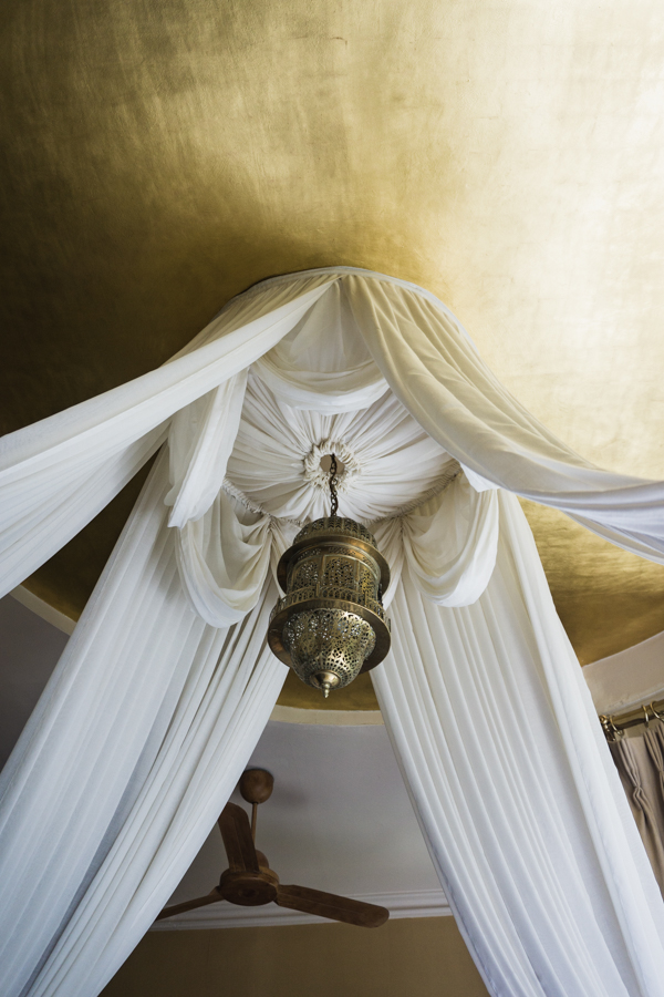 gold ceiling with drapes and light